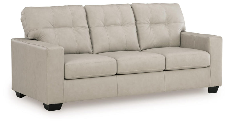 Ashley Furniture Santorine sofa in beige fabric, angled view showing plush cushions and modern design.