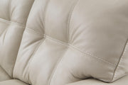 Ashley Furniture Santorine Sleeper Sofa in beige fabric, showing the stitched tufted upholstery and convertible design.