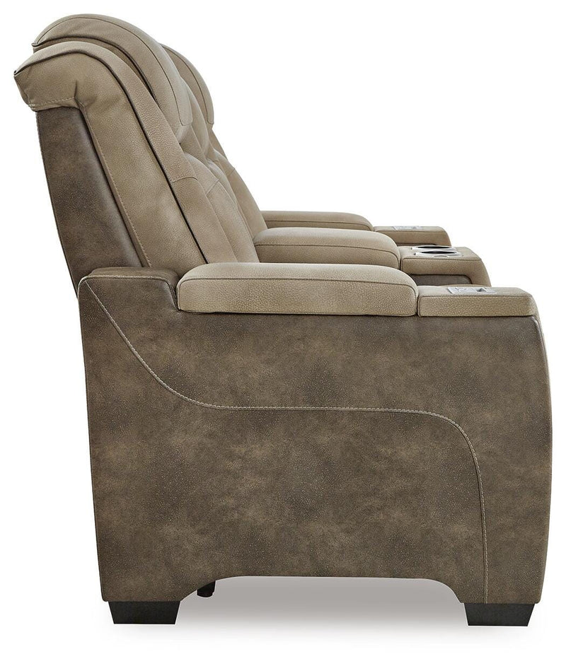 Ashley Furniture Next-Gen DuraPella power reclining loveseat with console, shown from the side with plush cushions and built-in cup holders.