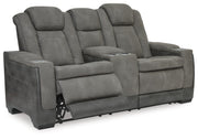Ashley Furniture Next-Gen DuraPella power reclining loveseat with console, shown from an angled open view showcasing plush seating.