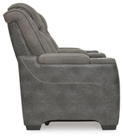 Ashley Furniture Next-Gen DuraPella power reclining loveseat with console, showing plush fabric and built-in cup holders.