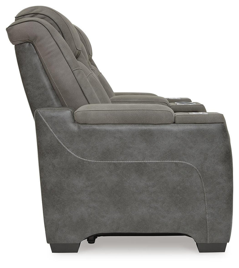 Ashley Furniture Next-Gen DuraPella power reclining loveseat with console, showing plush fabric and built-in cup holders.