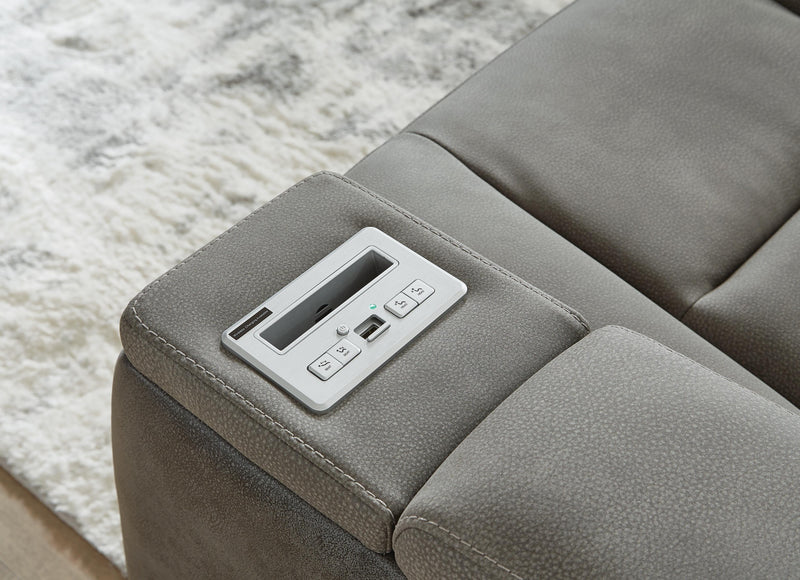 Ashley Furniture Next-Gen DuraPella Power Recliner with control panel, dark leather upholstery, and cushioned armrests.