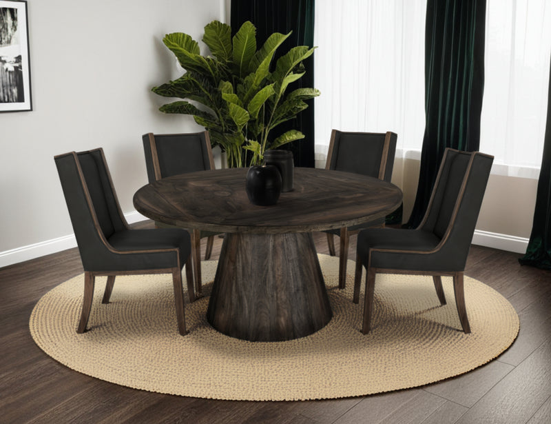 Black Balam round dining table by International Furniture Direct with a smooth wooden surface and sturdy base.