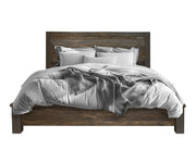 Brown King Bed by International Furniture Direct featuring a sturdy wooden frame and classic design, shown in a cozy bedroom setting.