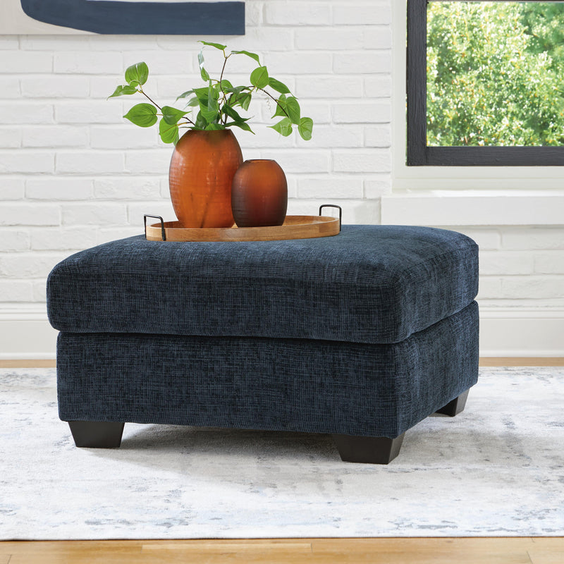 Oversized Ashley Furniture Aviemore accent ottoman with plush fabric and sturdy wooden legs, ideal for living room decor.