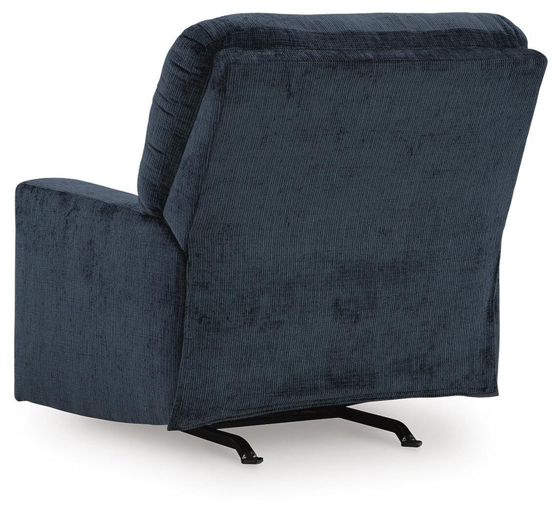 Ashley Furniture Aviemore recliner with plush upholstery and padded armrests, shown from the back in a comfortable living room setting.