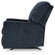 Ashley Furniture Aviemore recliner with plush upholstery and padded armrests, shown from the side in a cozy living room setting