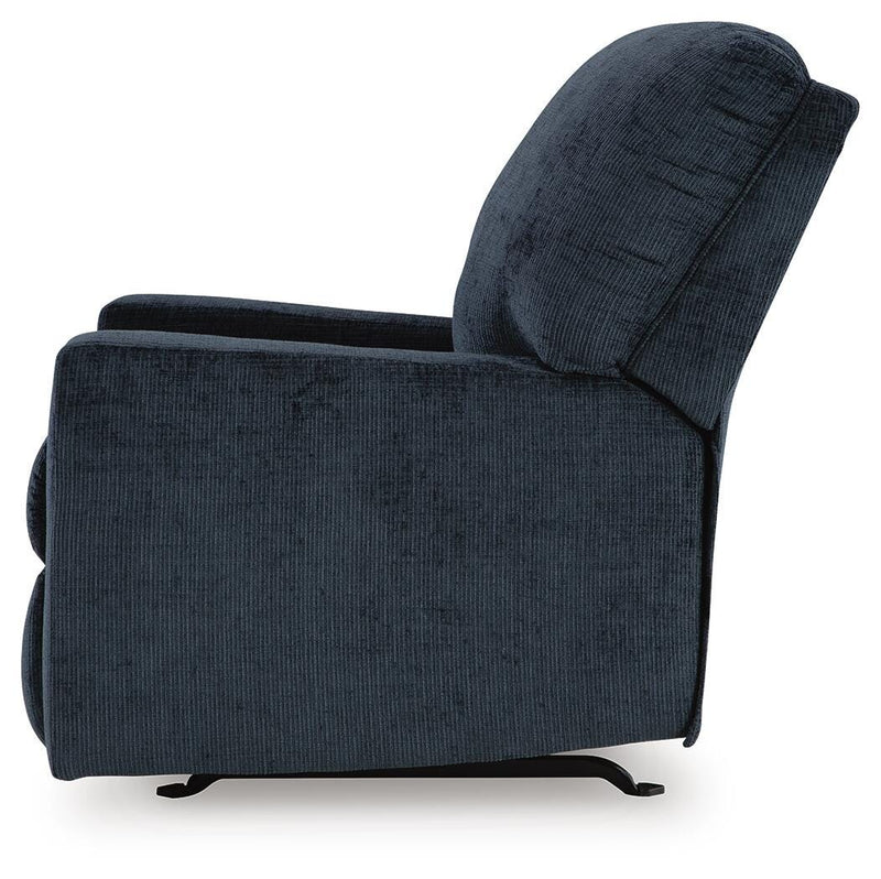 Ashley Furniture Aviemore recliner with plush upholstery and padded armrests, shown from the side in a cozy living room setting