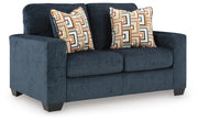Ashley Furniture Aviemore loveseat with plush fabric and modern design, shown from an angled view in a stylish living room setting.