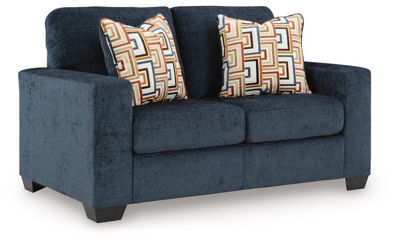 Ashley Furniture Aviemore loveseat with plush fabric and modern design, shown from an angled view in a stylish living room setting.