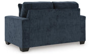 Ashley Furniture Aviemore loveseat with plush fabric and cushioned back, shown in a cozy living room setting.