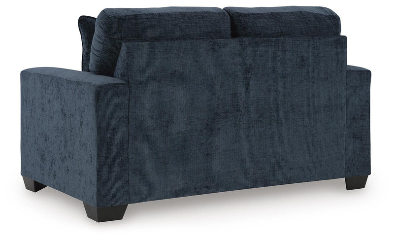 Ashley Furniture Aviemore loveseat with plush fabric and cushioned back, shown in a cozy living room setting.