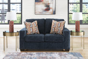 Ashley Furniture Aviemore loveseat with plush fabric and cushioned armrests, ideal for cozy living room seating.