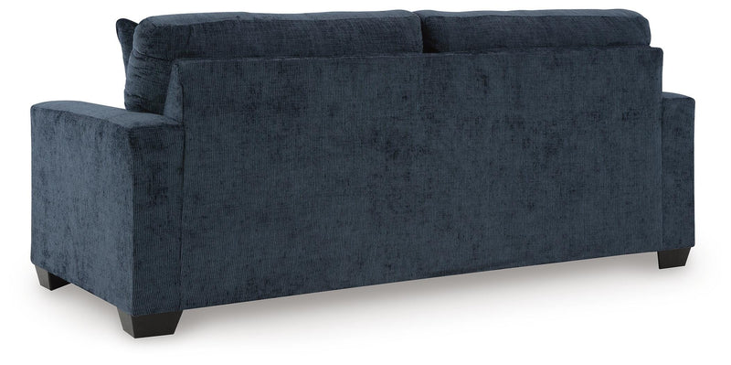 Ashley Furniture Aviemore sleeper sofa with plush fabric, shown in a stylish living room setting with back and side views.
