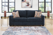 Ashley Furniture Aviemore Sleeper Sofa with plush fabric, featuring a fold-out bed and modern design, shown in a living room setting.