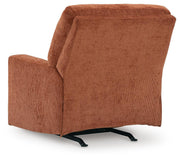 Ashley Furniture Aviemore recliner with plush upholstery and padded armrests, shown from the back in a modern living room setting.
