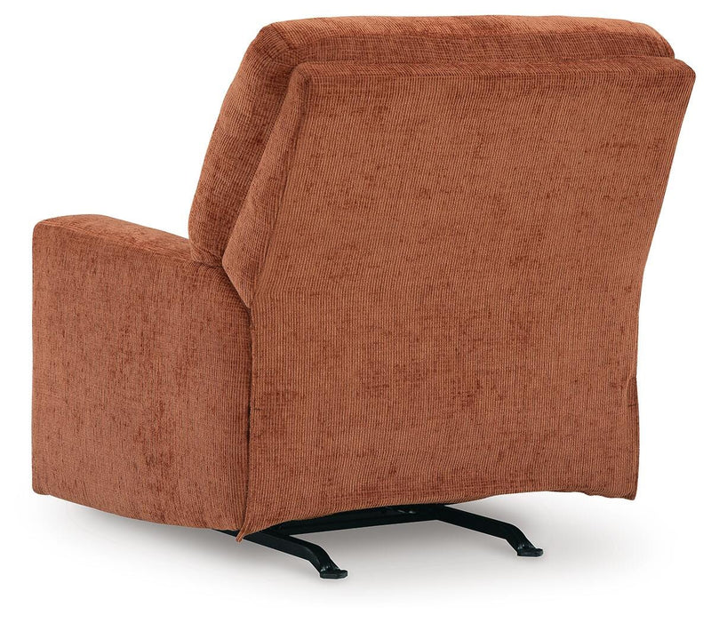 Ashley Furniture Aviemore recliner with plush upholstery and padded armrests, shown from the back in a modern living room setting.
