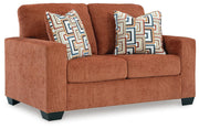 Ashley Furniture Aviemore loveseat with plush fabric and cushioned arms, shown from an angled side view.