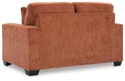 Ashley Furniture Aviemore loveseat with plush upholstery and cushioned backrest, shown in a cozy living room setting.