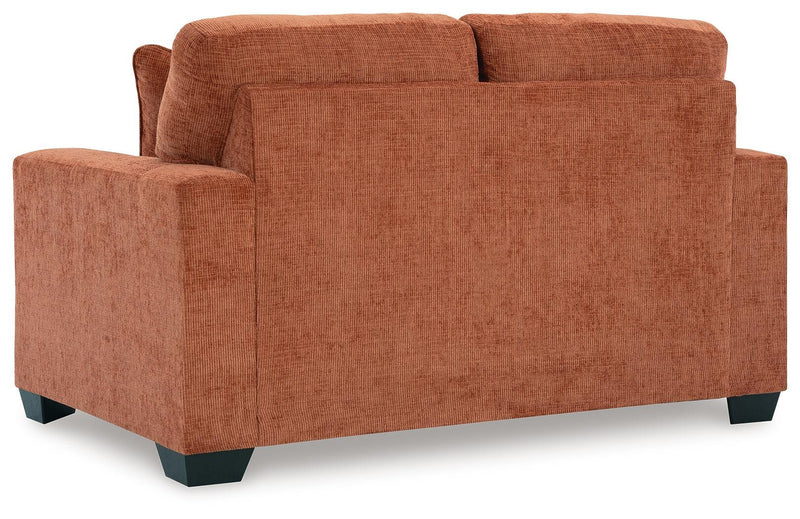 Ashley Furniture Aviemore loveseat with plush upholstery and cushioned backrest, shown in a cozy living room setting.