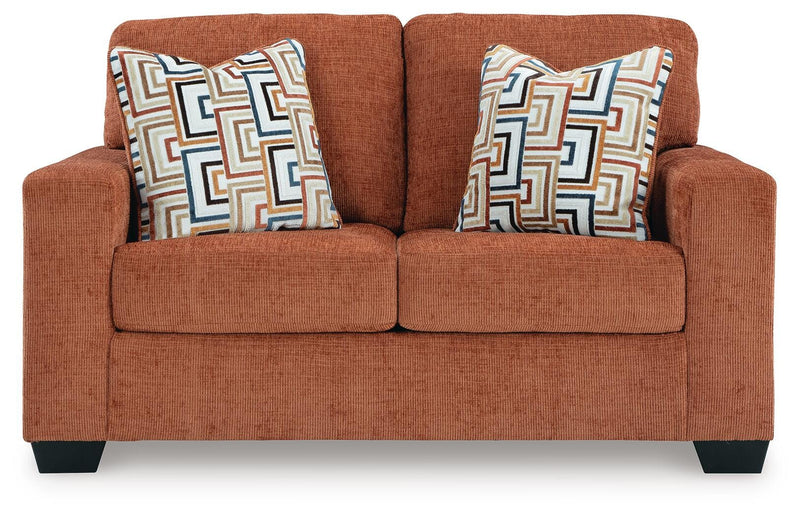 Ashley Furniture Aviemore loveseat with plush beige fabric, cushioned armrests, and comfortable seating for two.