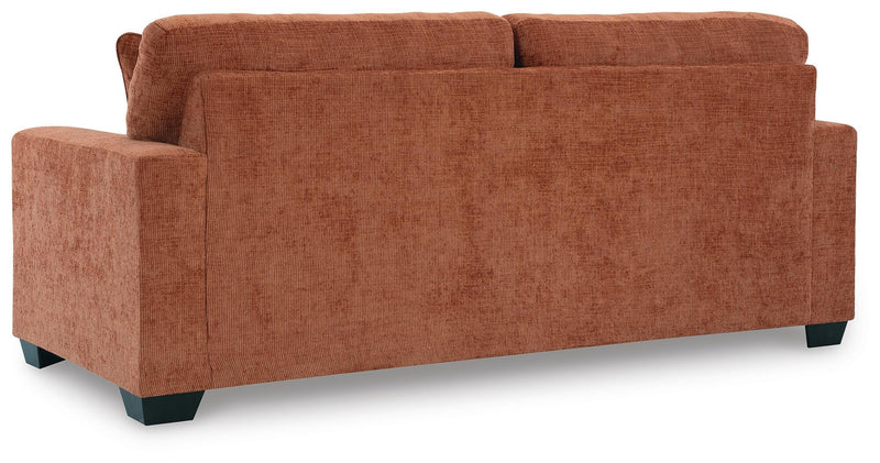Ashley Furniture Aviemore Sleeper Sofa with plush fabric, showing the back view and comfortable seating in a modern living room setting.