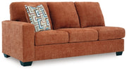 Ashley Furniture Aviemore sectional with chaise, featuring plush fabric and modern design, shown from an angled side view.