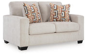 Ashley Furniture Aviemore loveseat with plush fabric and wooden legs, shown from an angled side view.
