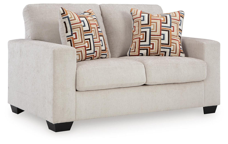 Ashley Furniture Aviemore loveseat with plush fabric and wooden legs, shown from an angled side view.