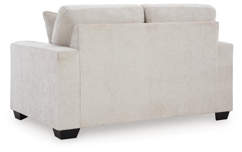 Ashley Furniture Aviemore loveseat with plush fabric and cushioned backrest, shown in a cozy living room setting.