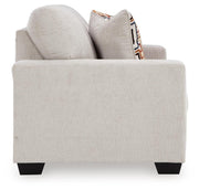 Ashley Furniture Aviemore loveseat with plush fabric and cushioned armrests, shown in a living room setting.
