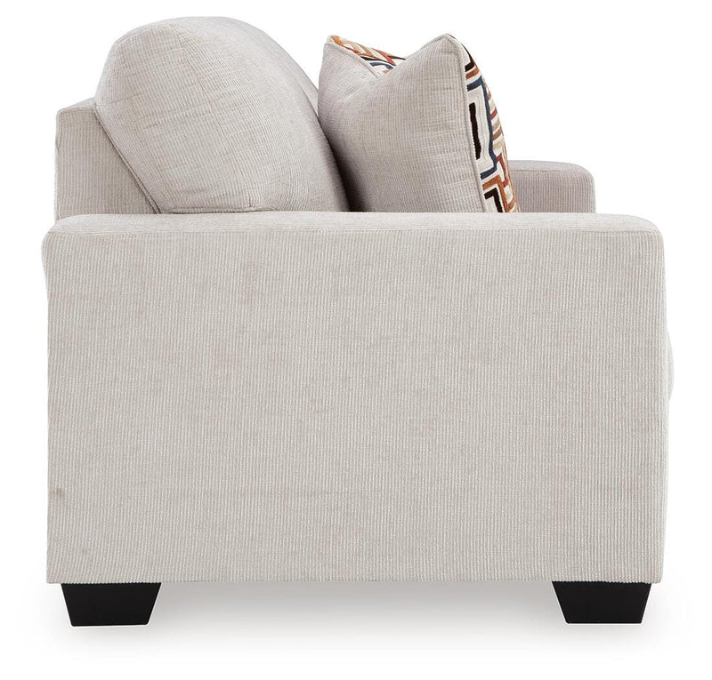 Ashley Furniture Aviemore loveseat with plush fabric and cushioned armrests, shown in a living room setting.