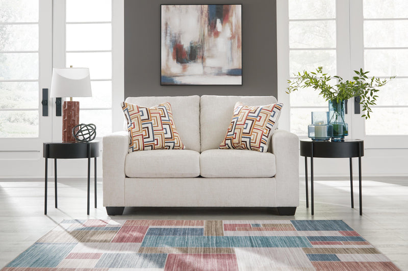 Ashley Furniture Aviemore loveseat with plush fabric and cushioned arms, shown in a cozy living room setting.