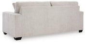 Ashley Furniture Aviemore sleeper sofa with plush back cushions and neutral fabric upholstery, shown from the back view.