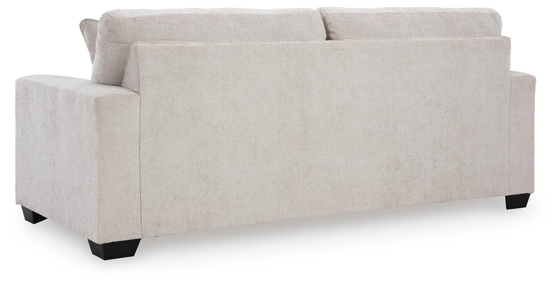 Ashley Furniture Aviemore sleeper sofa with plush back cushions and neutral fabric upholstery, shown from the back view.