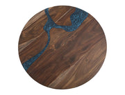 Round dining table by International Furniture Direct, featuring a polished wood surface and sturdy wooden legs.