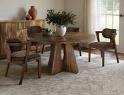 Round dining table with a natural wood finish by International Furniture Direct, featuring a sturdy design and classic style.