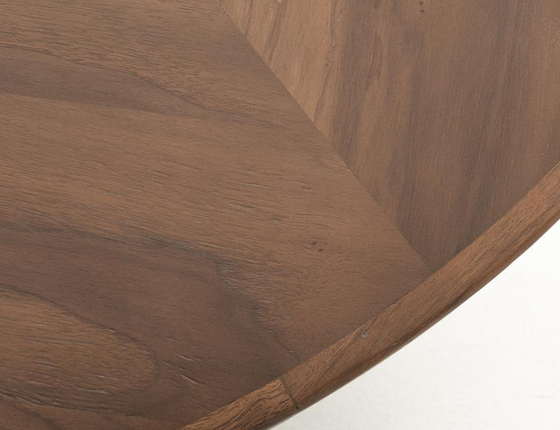 Round dining table by International Furniture Direct, Balam 47, featuring a polished wood surface and sturdy base.