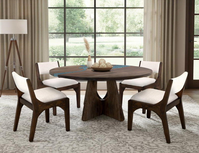 Round dining table by International Furniture Direct with a smooth wooden surface and sturdy legs for modern dining spaces.