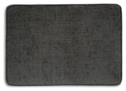 Ashley Furniture Erinslane Ottoman with soft fabric upholstery and wooden legs, shown in a close-up top view.