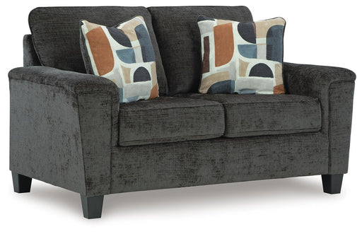 Ashley Furniture Erinslane loveseat in beige fabric, showing angled view with plush cushions and wooden legs.