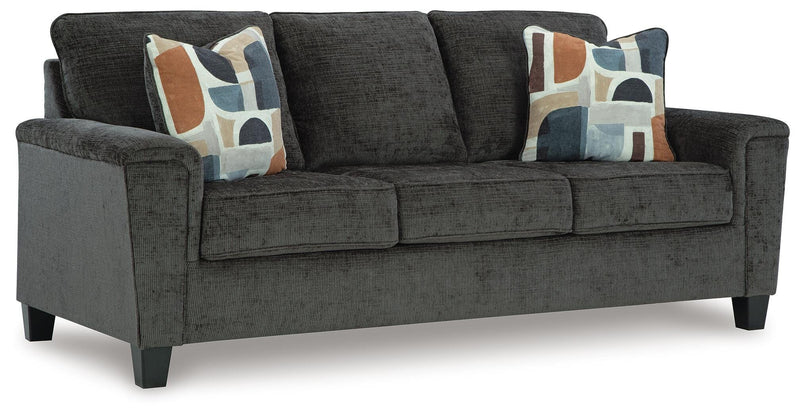 Ashley Furniture Erinslane sofa shown from an angle, featuring plush cushions and a neutral fabric upholstery.