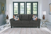 Ashley Furniture Erinslane Sofa with plush cushions and neutral fabric, shown in a cozy living room setting.