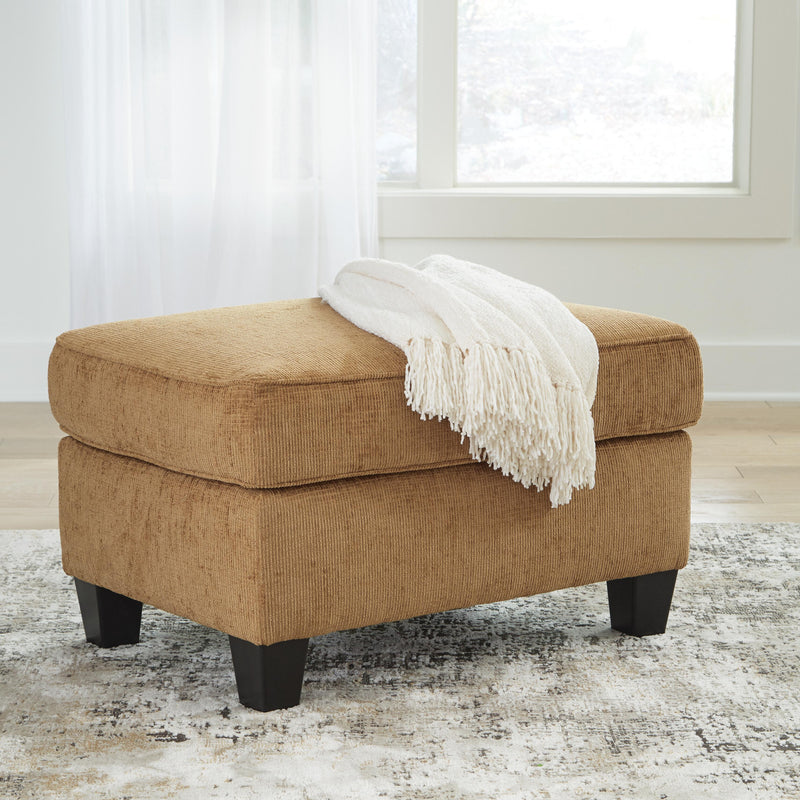 Ashley Furniture Erinslane Ottoman in neutral fabric, showcasing its plush top and sturdy wooden legs for versatile living room decor.