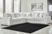 Ashley Furniture Stupendous sectional sofa with plush cushions and modern design, shown in a spacious living room setting.