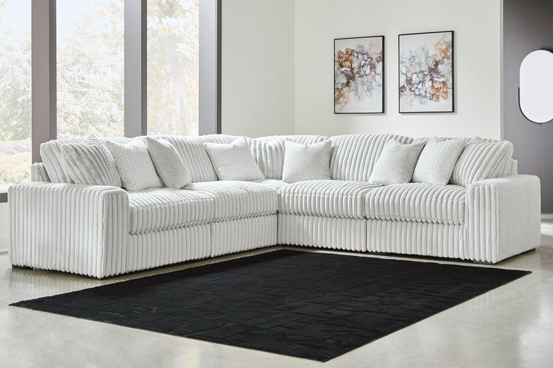 Ashley Furniture Stupendous sectional sofa with plush cushions and modern design, shown in a spacious living room setting.