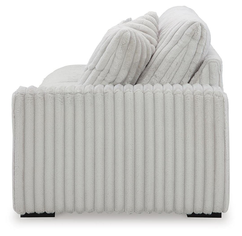 Ashley Furniture Stupendous sectional sofa with plush cushions and modern design, shown from a side view against a neutral background.