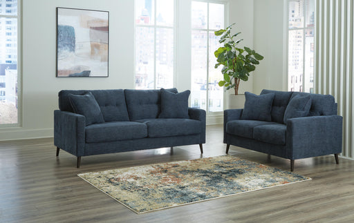 Ashley Furniture Bixler living room set with sofa, loveseat, and armchair in neutral fabric, arranged in a modern living space.