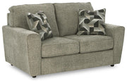 Ashley Furniture Cascilla loveseat with plush fabric and cushioned armrests, shown from an angled view.
